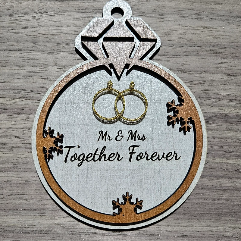 Layered wood anniversary ornament shaped like a diamond ring with gold glitter wedding rings and Mr & Mrs Together Forever text